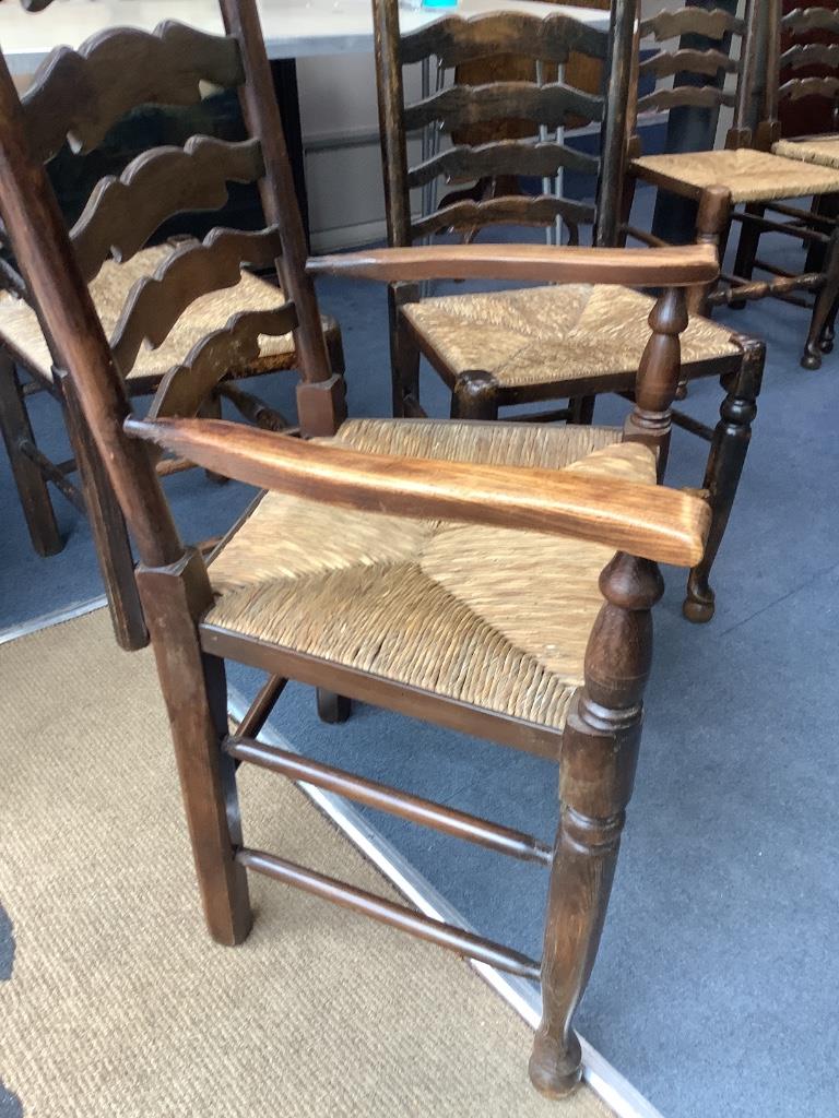 A set of twelve ash rush seat ladder back dining chairs (two with arms)